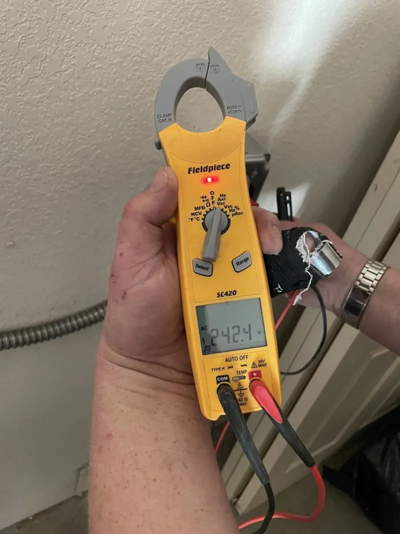 Voltage testing with clamp meter during Whole House Surge Protector in Eden Prairie